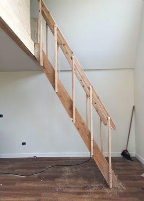 We installed a ladder, daybed, and bookshelves in this loft in order to create a space that was warm and inviting.