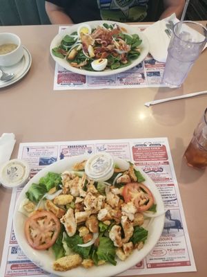 Chicken cesar salad (foreground) and spinach salad.