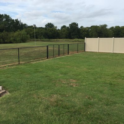 Vinyl fence with 4' black chain link fence