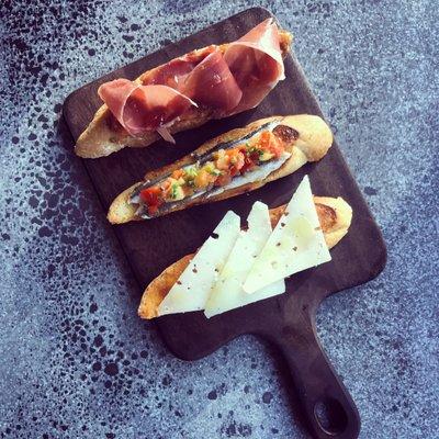 Trio de Tostadas: Tomate y Jamon/ Boqueron y Pisto/ Membrillo y Manchego