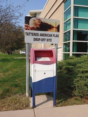 Drop box for tattered American Flags south west corner of building.