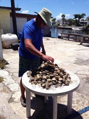 Captain Keith pouring out the scallops we caught.