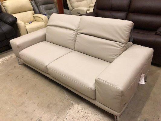 Stationary sofa with manual ratcheting headrests so you can make the backs flat for clean look and also pull them up for movie night