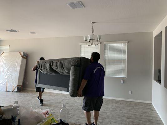 Nate and Chase arranging furniture in the new home - Hickle Family Moving