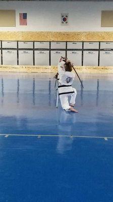 Our Instructor Stephenie Gayler demonstrating a sword form at her testing.