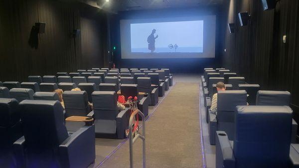 One of the smaller cinema viewing rooms. All seating is reserved with comfortable recliners.