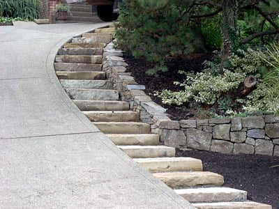 Single stone steps by steep driveway.