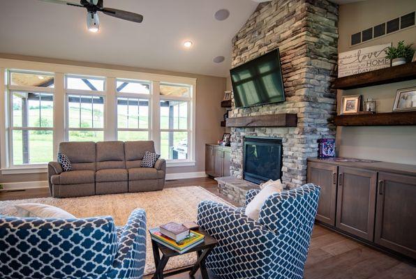 The EcoTek 3200 Series Double-Hung Windows in this great room provide natural light and expansive views, complementing the stone fireplace a