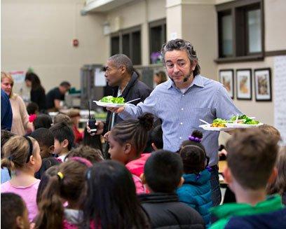 Chef Matthias Merges serving lunch to excited students