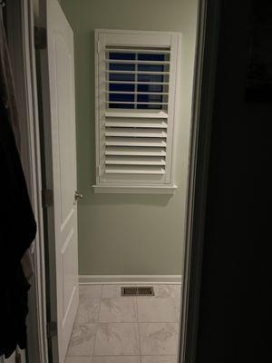 Primary bathroom shutter with dual control for privacy and light.