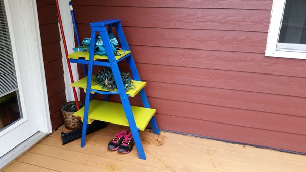 An old ladder painted for a plant stand!