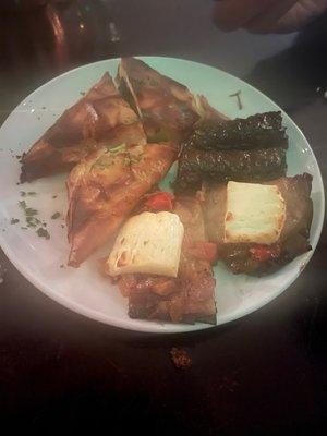 Spinach pie slices, stuffed grape leaves and eggplant w/cheese.