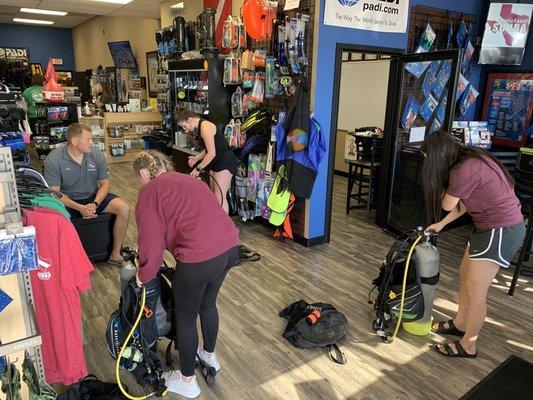 Open water classes assembling gear before heading to the pool