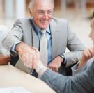 Business partners handshaking after striking a great deal