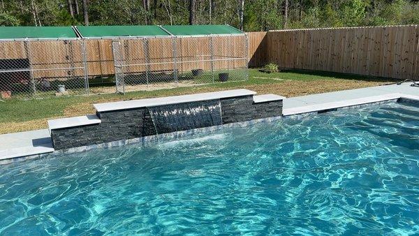 12' Raised wall with 4' sheer descent water with black ledgestone