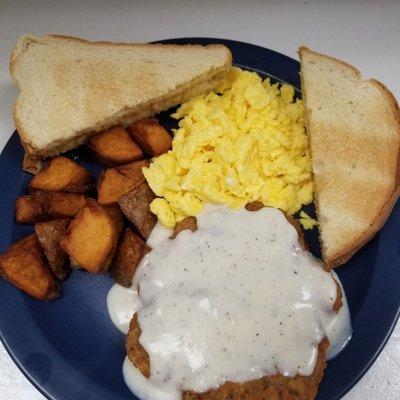 Country fried Steak/gravy/scrambled eggs/fried potatoes/toast