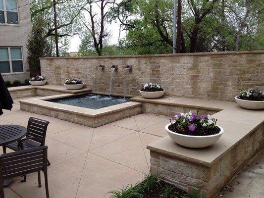 Retaining wall water feature, complete with matching planters.