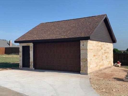 Garage with stone exterior.