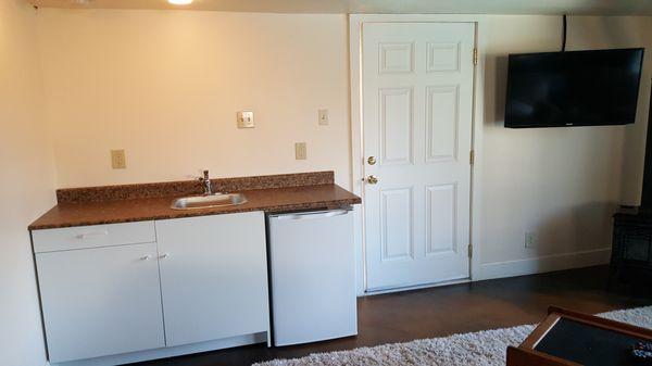 Addedcabinet, sink and door to outside and hung TV