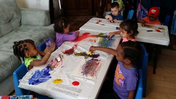 Painting with cars! We do all types of activities with the children to help them learn as they play.