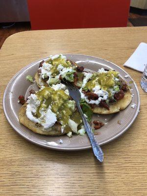 Sopes al pastor with cotija and salsa verde.