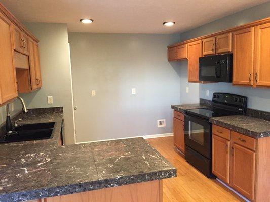 Total kitchen remodel. marble tile counter tops, bamboo flooring, new chefs sink and faucet.