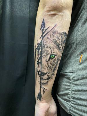 Lioness, arrow, black and grey with a hint of color in the eye. Quarter sleeve.