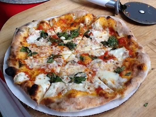 Margherita Pizza. Simple, local ingredients combined with our home made dough and sauce to create an amazing pizza experience.