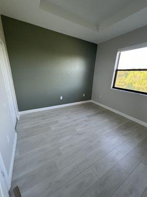 This master room was all white and we brought it to life with the light grey and one green wall for contrast