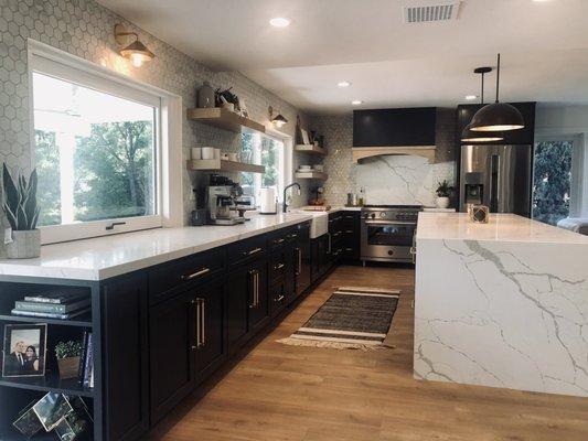 Kitchen with waterfall island and counter to ceiling backsplash.