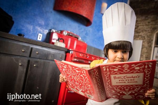 4 year old baking cookies as part of her photo shoot.