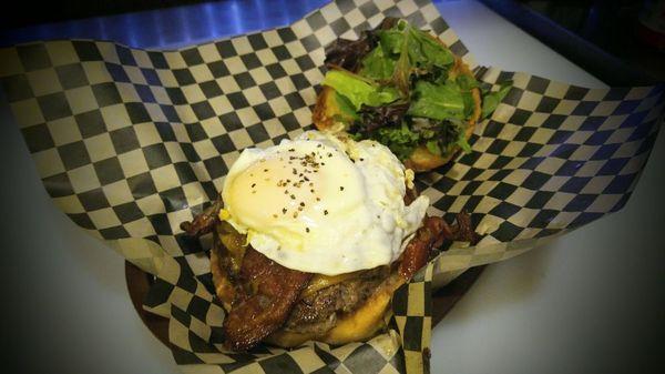 The Hamborghini. 1/2lb Seasoned onion beef patty, cheddar, roasted Hatch green chile, spring greens, buttered pub bun.(Fried egg/bacon xtra)