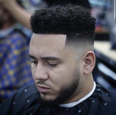 Curly top with a Mid bald fade