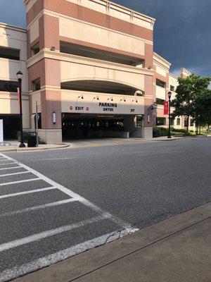 Entrance to the parking garage with Tesla flags waving.