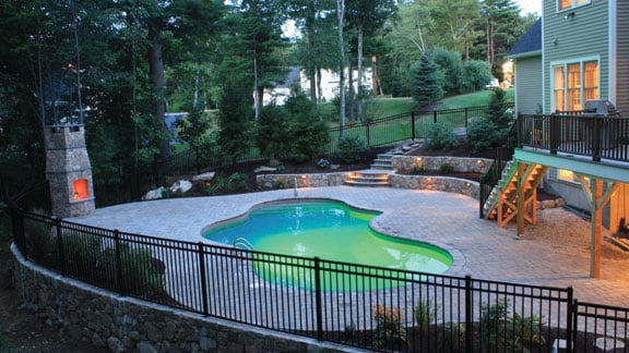 Fieldstone walls, steps and fireplace; liner swimming pool, concrete coping and pavers; landscape planting and irrigation