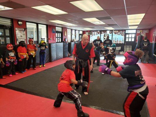 Master James Parson teaching his kids class the basics.