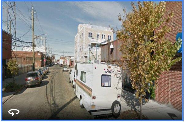 On the street: the entrance for 'Just Four Wheels' is just up to the right in front of this camper...