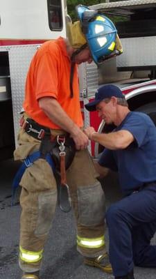 getting strapped in prior to tackling the extension ladder