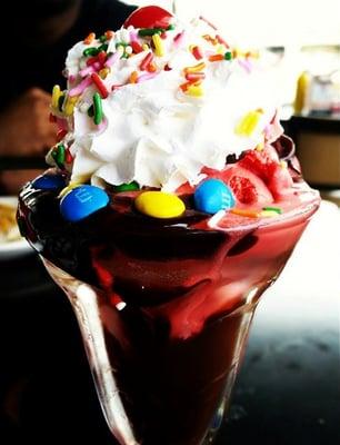 Single scoop red velvet sundae with whipped cream, sprinkles and M&Ms