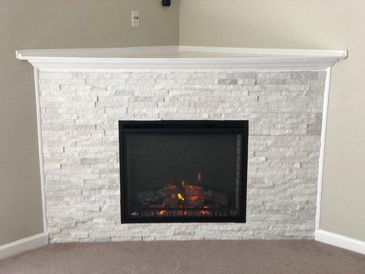 New electric fireplace with stone surround.