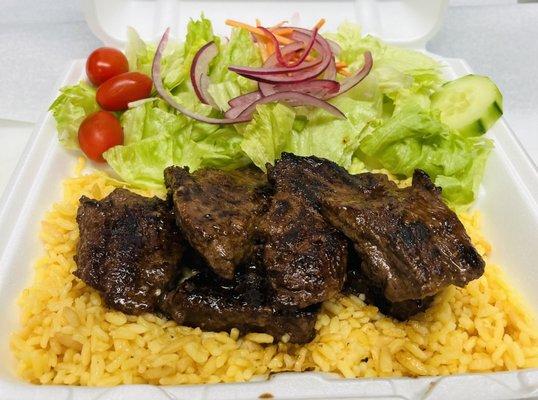 Steak tips over rice.