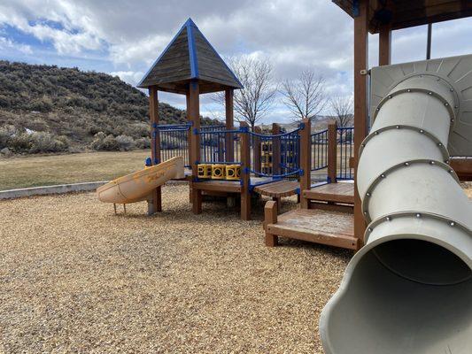 The two slides on the bigger playground