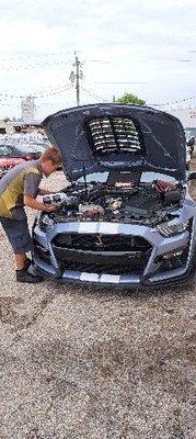 Zack, the head mechanic installing a supercharger pulley, thermostat, & oil catch can on a 2022 gt500