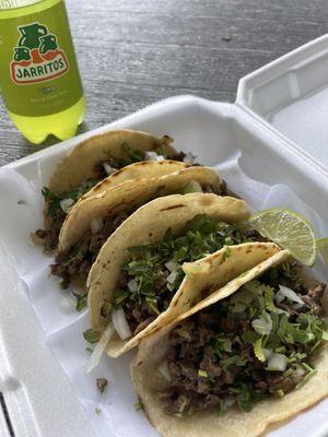 Mexican style steak tacos with lime Jarritos.