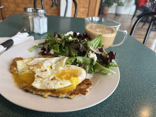 Eggs on a rice cake with salad and feta