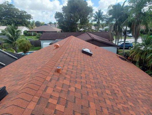 Slope shingle reroof with sky lights in Welleby (Sunrise, FL) featuring Duration Terra Cotta shingles manufactured by Owens Corning