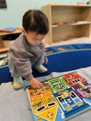 This work develops the hand eye coordination and fine motor skills. For a 1.5 year old, it is not easy to open and close all kinds of locks