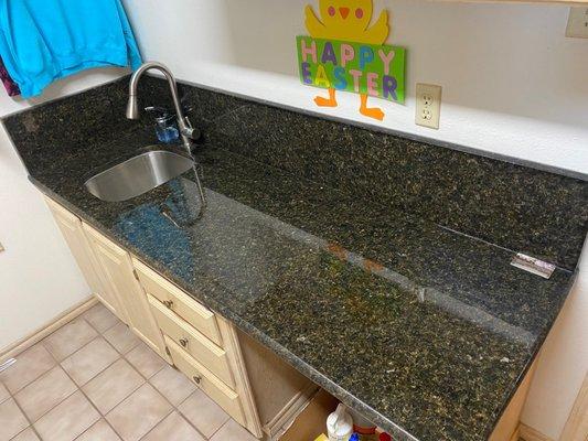 new utility room granite top and stainless steel sink with drop down faucet