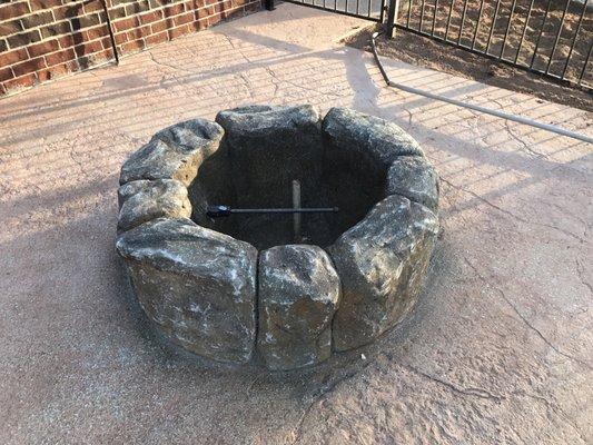 Natural gas "boulder" fire pit.  This one burns both wood, and gas.