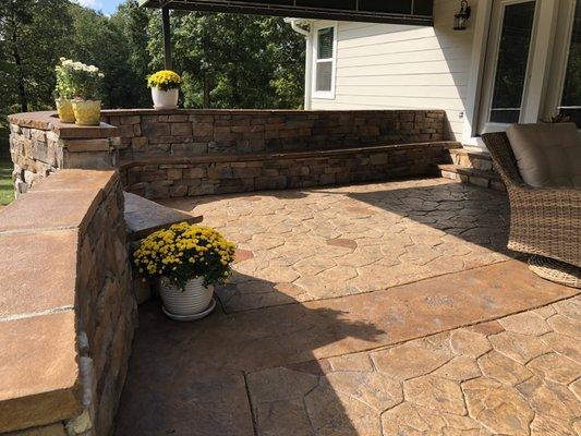 Custom Random Stone Concrete Patio with stone retaining wall & fire pit